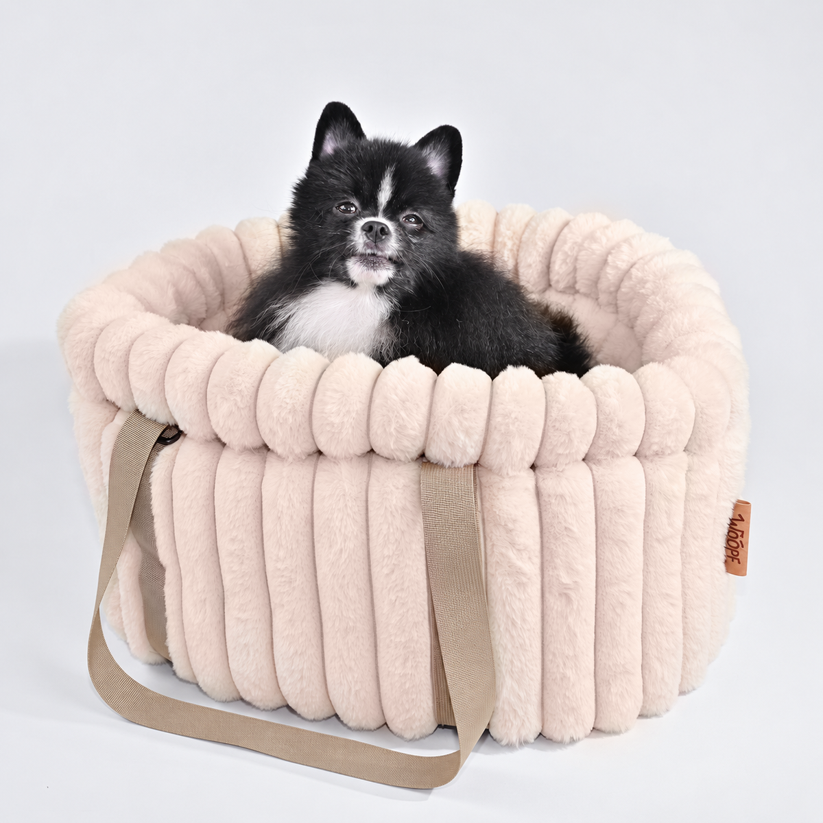 Pale pink | Corduroy Calming Dog Carrier: Black and white Pomeranian sitting in the Pale pink carrier in a grey studio