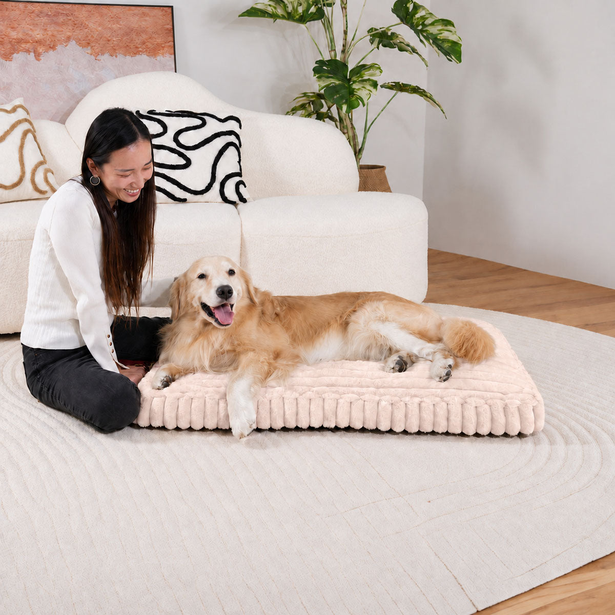 Pale pink | Furry Corduroy Sleeping Mat: Woman sitting beside a golden retriever lying on the Pale pink mat