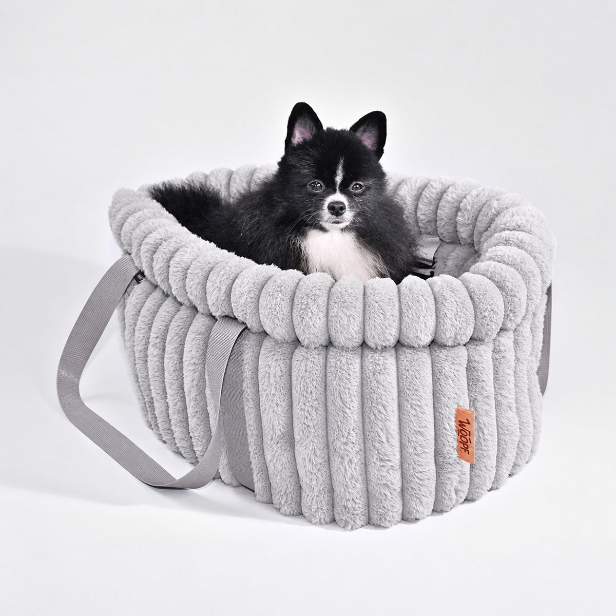 Grey | Corduroy Calming Dog Carrier: Black and white Pomeranian sitting in the Grey carrier in a grey studio