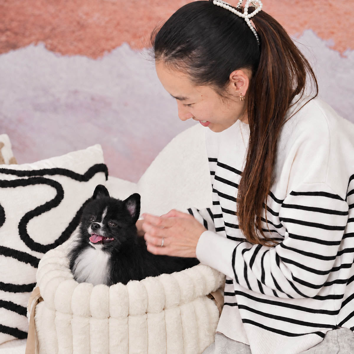 White | Corduroy Calming Dog Carrier: Woman smiling at a black and white Pomeranian in the White carrier