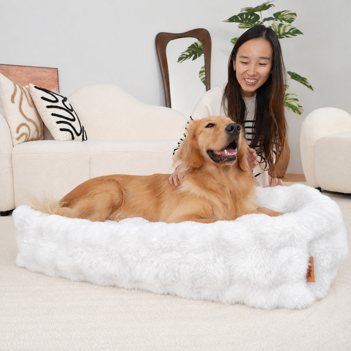 White | Furry Curves Rectangle Bed: Woman beside a golden retriever in the White bed