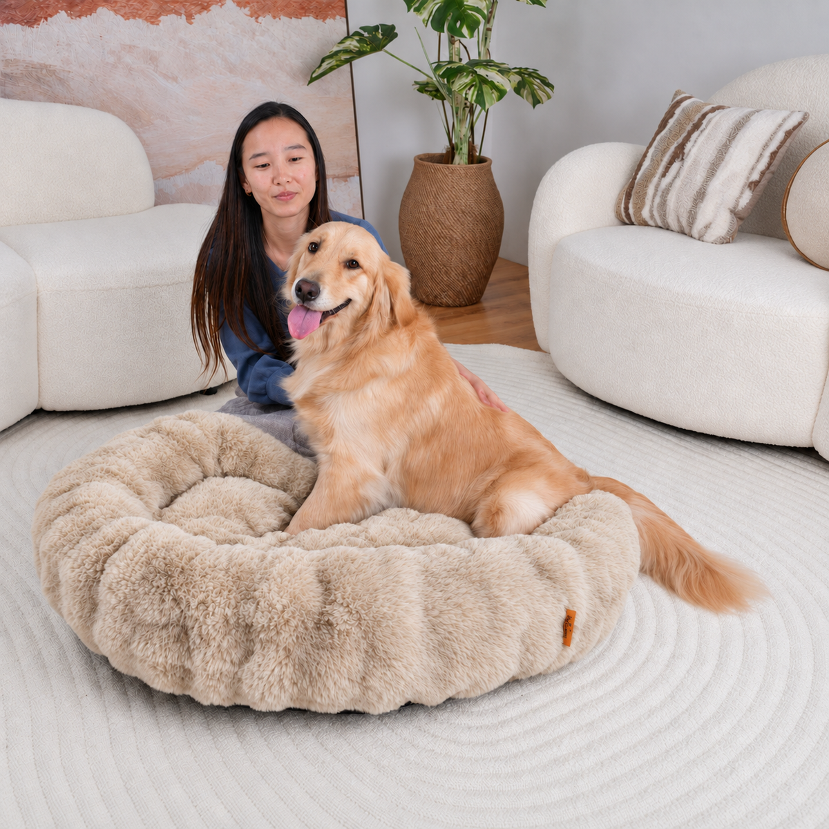 Cream | Furry Curves Round Bed: A woman sitting behind a golden retriever in the Cream round bed