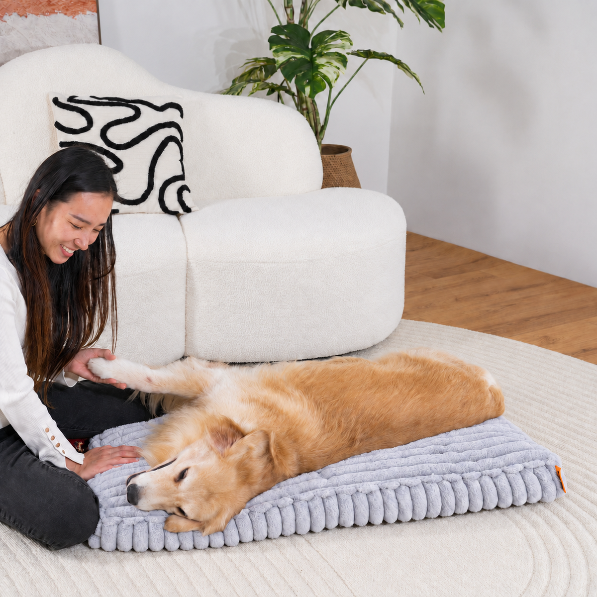 Grey | Furry Corduroy Sleeping Mat: Woman kneeling beside a golden retriever asleep on the Grey mat