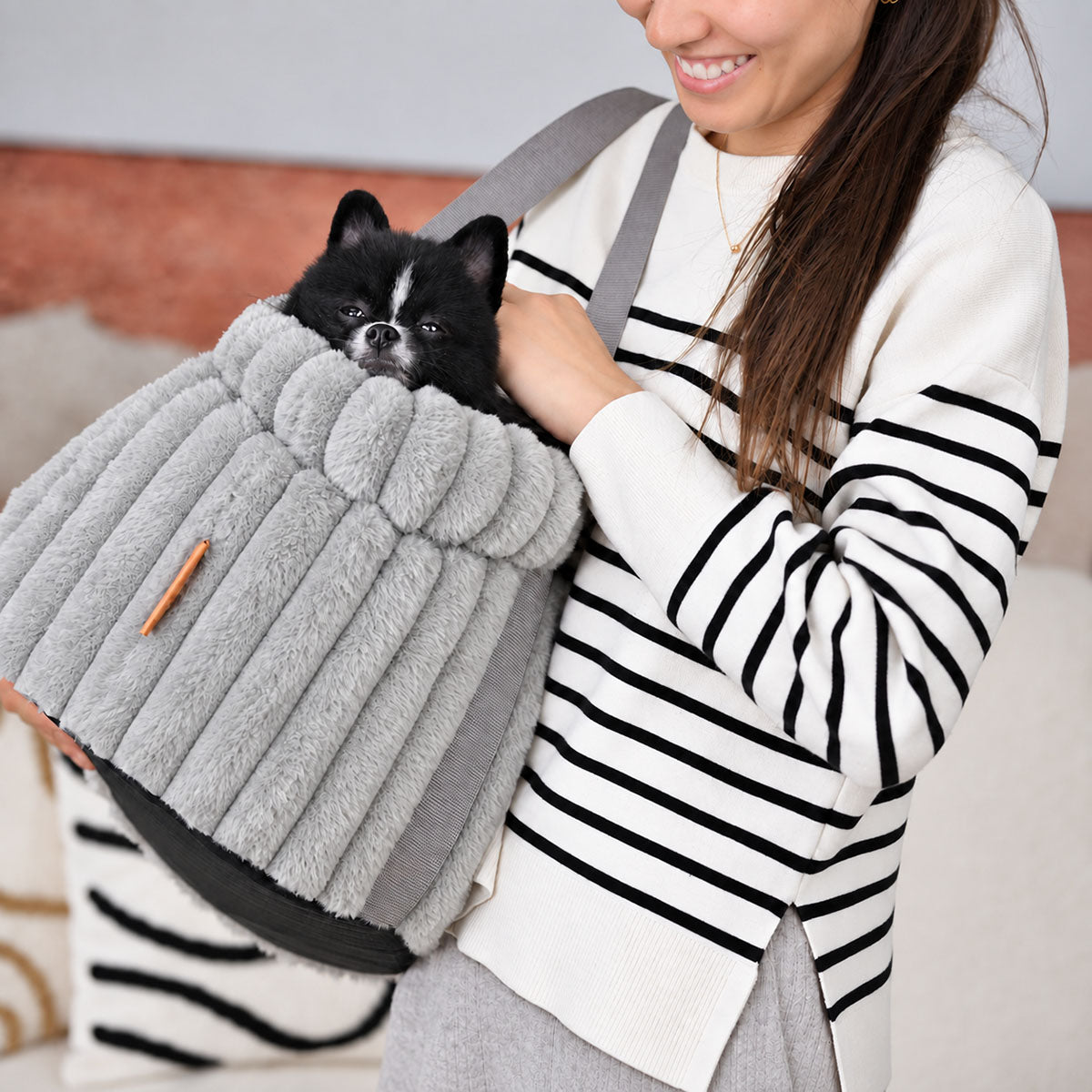 Grey | Corduroy Calming Dog Carrier: Woman carrying a black and white Pomeranian in the Grey carrier