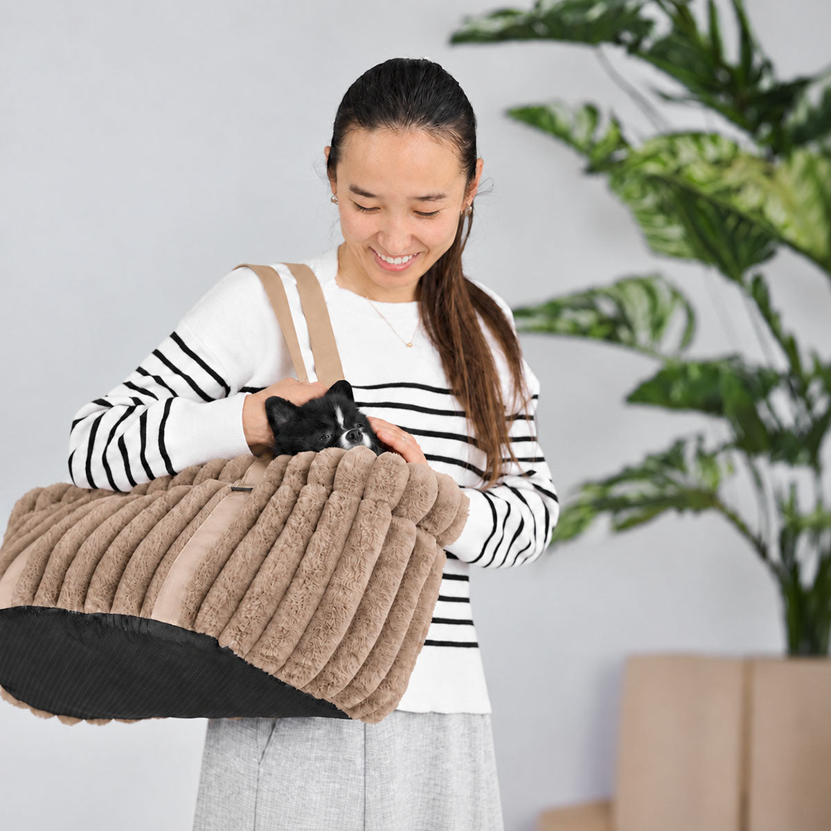 Brown | Corduroy Calming Dog Carrier: Woman carrying a black and white Pomeranian in the Brown carrier
