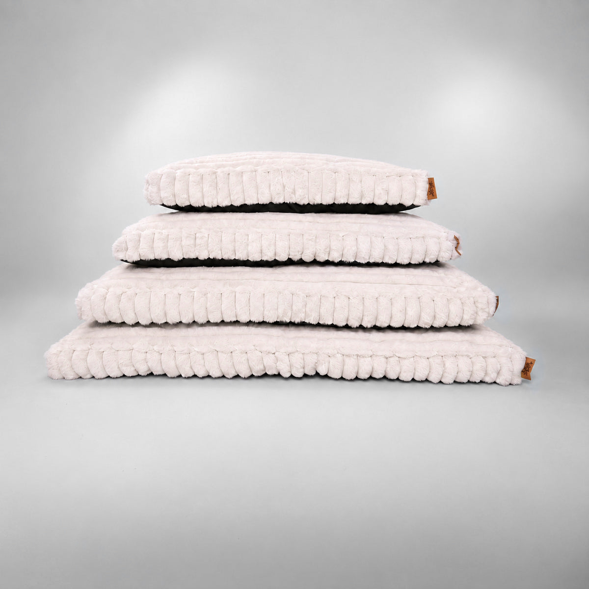 Pale pink | Furry Corduroy Sleeping Mat: Four Pale pink mats stacked from Extra large at the bottom to Small at the top