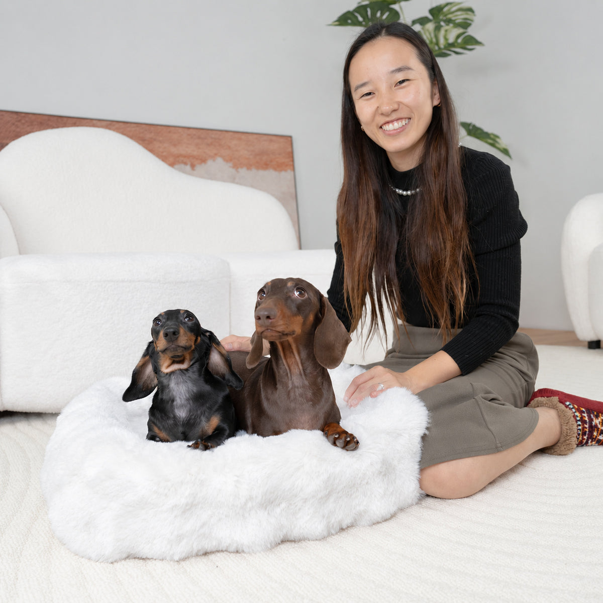 White | Furry Curves Rectangle Bed: Woman sitting with two dachshunds in the White bed
