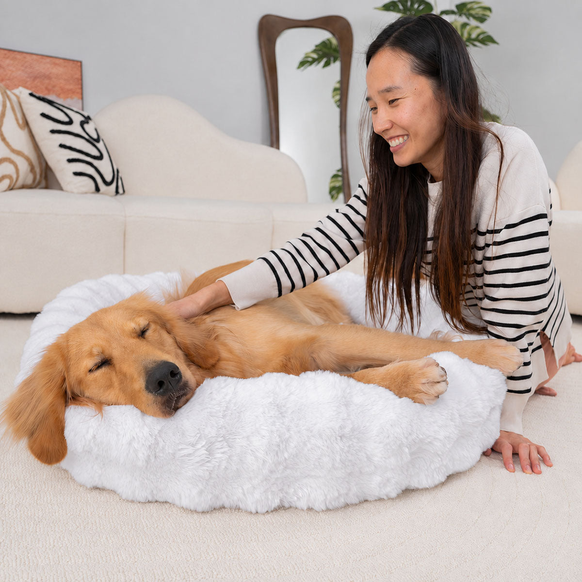 White | Furry Curves Round Bed: A woman stroking a golden retriever asleep in the White round bed