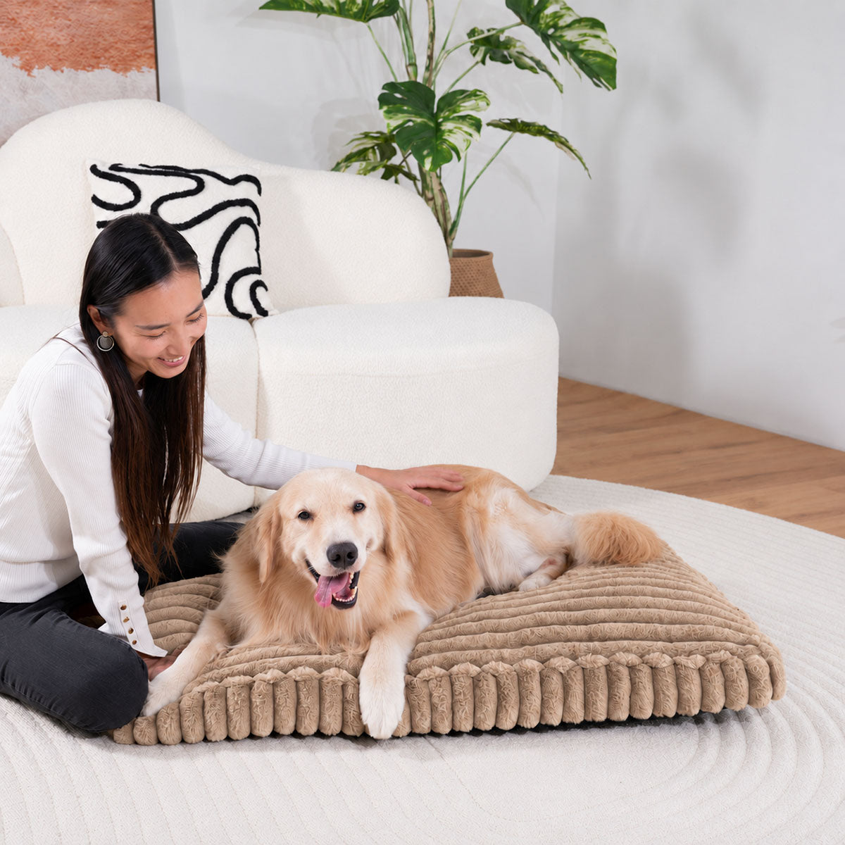 Brown | Furry Corduroy Sleeping Mat: Woman kneeling beside a golden retriever lying on the Brown mat in a living room