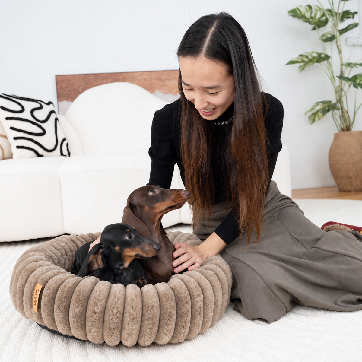 Brown | Furry Corduroy Round Bed: Woman kneeling beside two dachshunds in the Brown bed