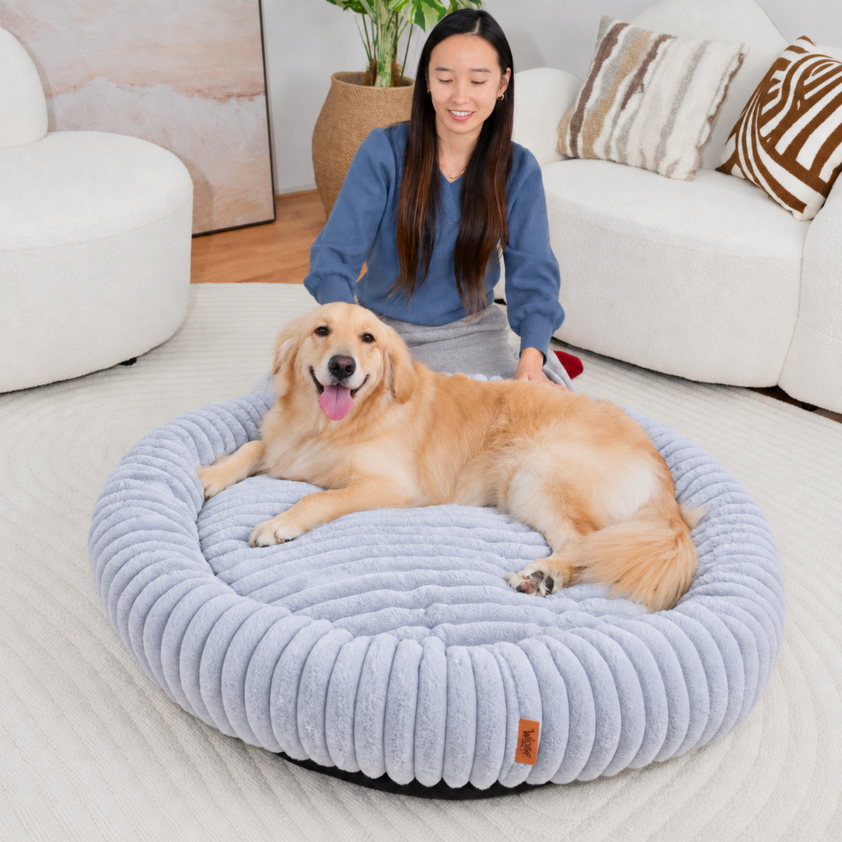 Grey | Furry Corduroy Round Bed: Woman behind a golden retriever lying in the Grey bed