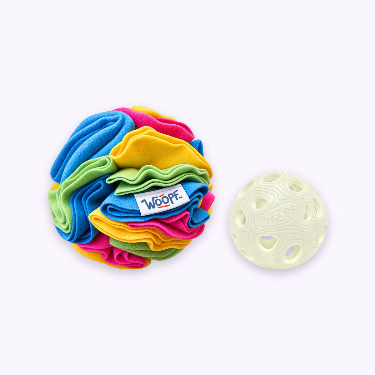 Glow | Chase & Sniff Bundle: The Glow MeteorBite Ball with the Snuffle Ball With Crackles on a pale lavender background