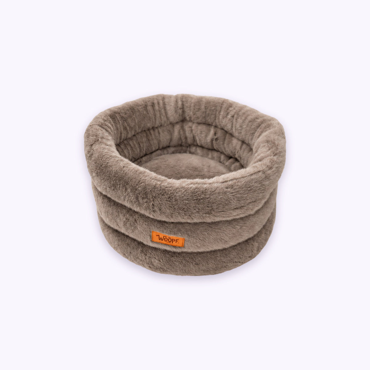 Furry Range Round Bed: The Brown bed on its own on a pale lavender background