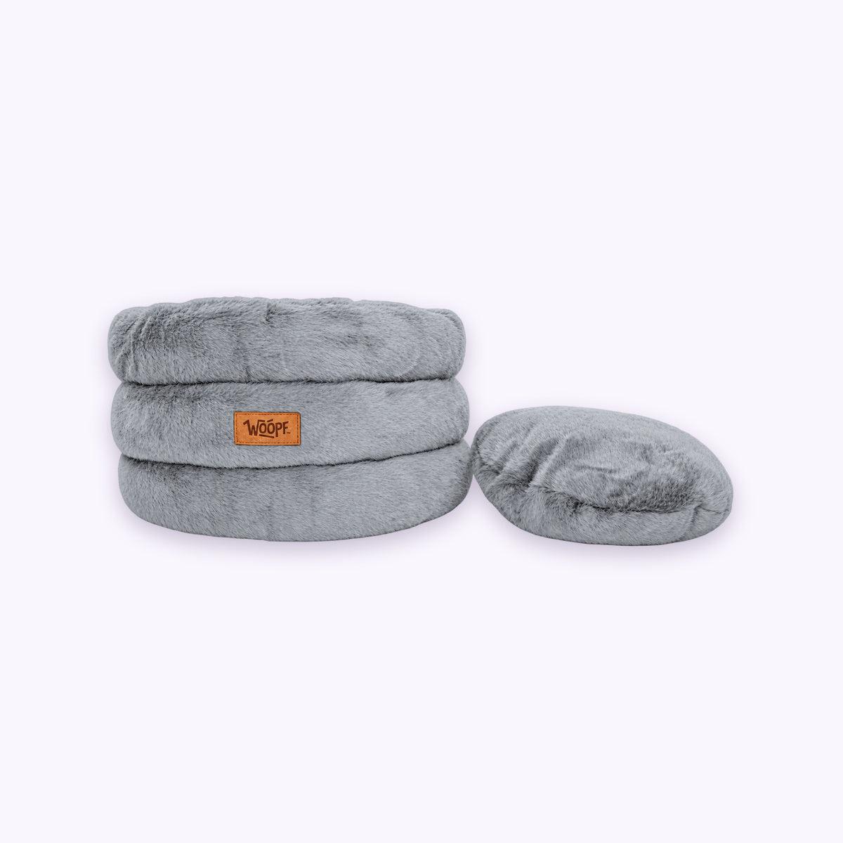Grey | Furry Range Round Bed: The Grey bed with its round cushion beside it on a pale lavender background