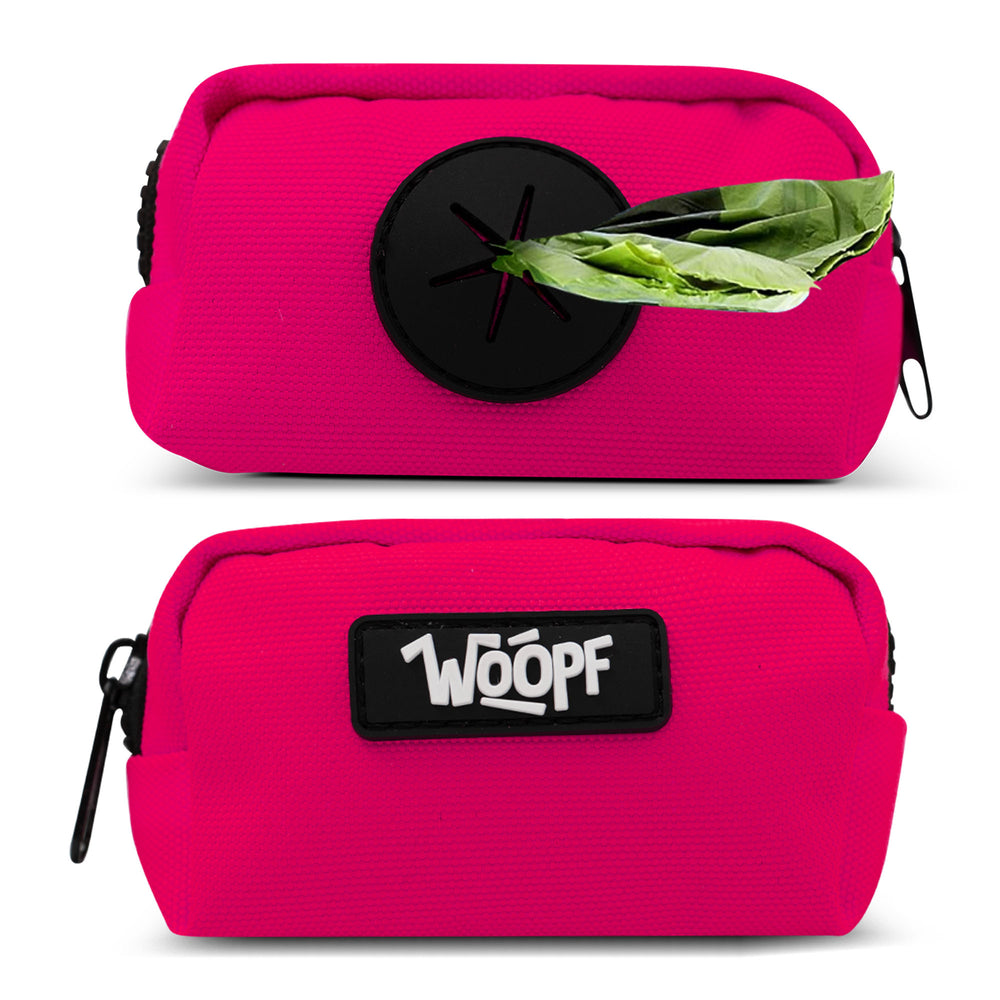 Pink pouch with a black circular object and green leaf on top, featuring the brand 'WOOPF'.