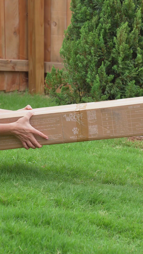 Black | Chew-Proof Dog Hammock: Video of hands fitting the Black mesh bed onto its frame on a lawn