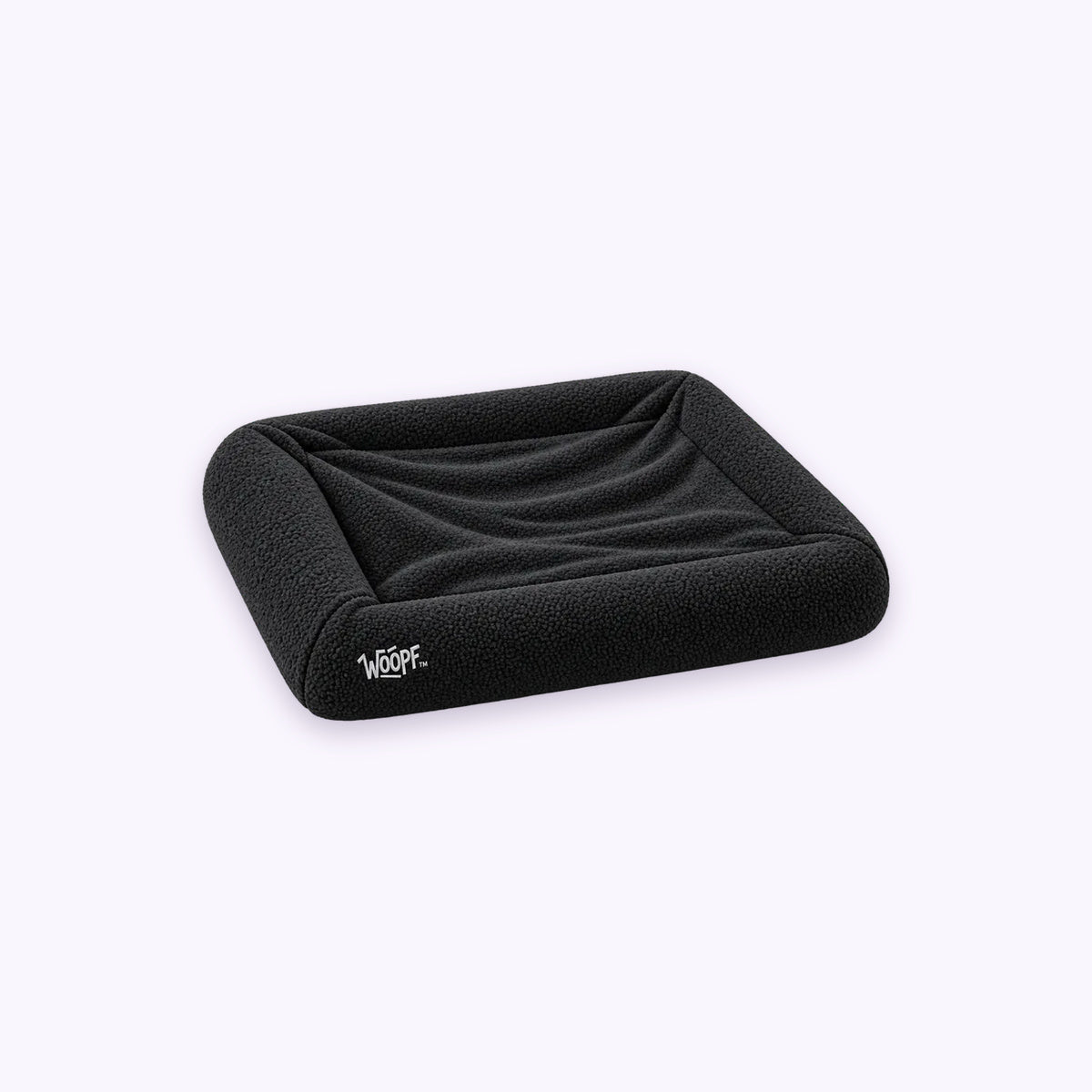 Black | SNÜZ Bed Slip-On Cover Fleece: The Black cover on the bed on its own on a pale lavender background