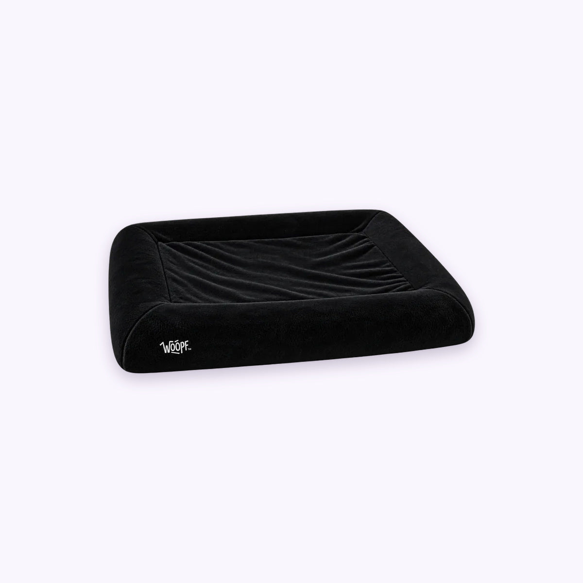Black | SNÜZ Bed Slip-On Cover (Faux Velvet Fur): The Black cover on the bed on its own on a pale lavender background