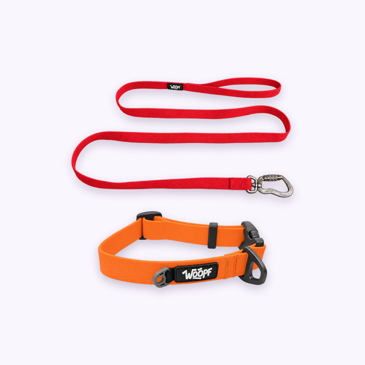 Orange | Swimmer Bundle: The Orange Sealskin Waterproof Dog Collar with the Red Sealskin Lightweight Waterproof Leash on a pale lavender background